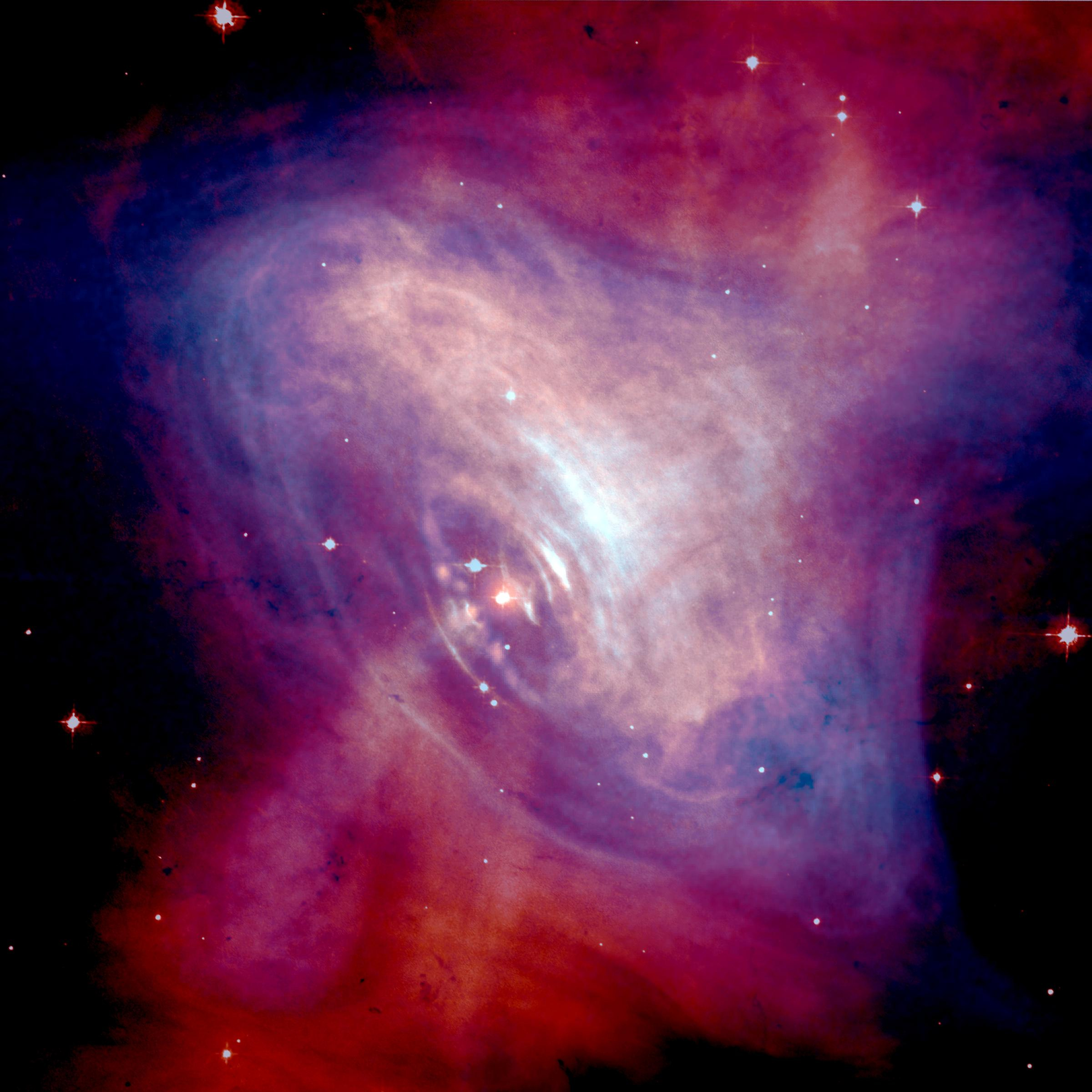 This composite image of the Crab Nebula shows x-ray (blue) and optical (red) sup.jpg